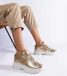 Gemre Caraballo women's gold sneakers with glitter inserts