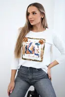 Blouse with 3D graphics and decorative pom pom white