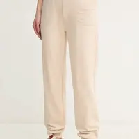 Bavlněné tepláky Calvin Klein Jeans béžová barva, s aplikací, J20J225355