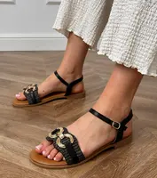 Gemre Black flat sandals with a gold Melona ornament