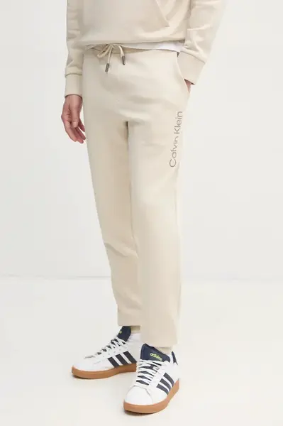 Bavlněné tepláky Calvin Klein béžová barva, s aplikací, K10K114254