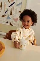 Detský pršiplášť Liewood Merle Printed Cape Bib