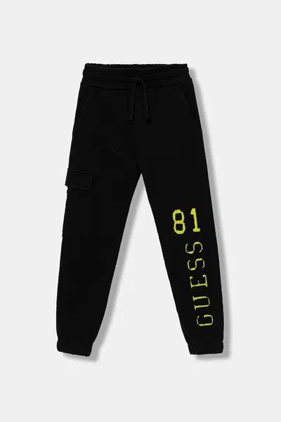 Dětské bavlněné tepláky Guess černá barva, s potiskem, L5YQ13 KAD74