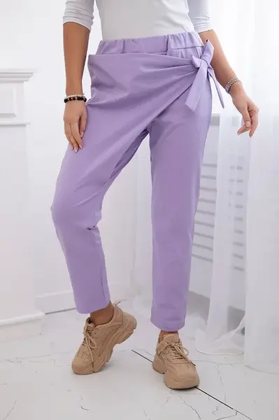 Trousers tied with an asymmetrical light purple front
