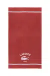Bavlněný plážový ručník Lacoste LORIGINE Sierra 90 x 160 cm vínová barva