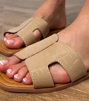 Gemre Brown flat-soled sandals with Sarini embossing