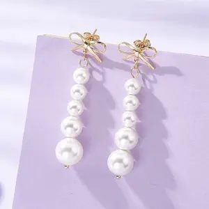 Shell Pearl Bowknot with Round Tassel Stud Earrings