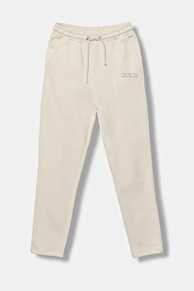 Dětské bavlněné tepláky Guess béžová barva, s aplikací, J5YQ17 KAV34