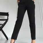 Black trousers decorated with gold Coomore buttons