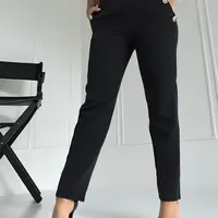 Black trousers decorated with gold Coomore buttons