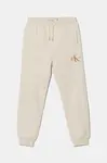 Dětské bavlněné tepláky Calvin Klein Jeans béžová barva, IU0IU00285
