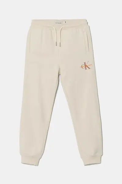 Dětské bavlněné tepláky Calvin Klein Jeans béžová barva, IU0IU00285