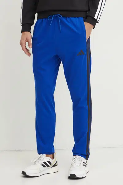Tepláky adidas Essentials modrá barva, vzorované, JE6432