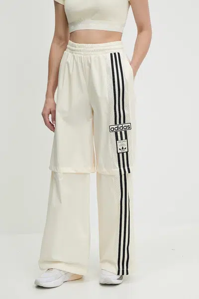 Tepláky adidas Originals Woven Trackpant dámské, béžová barva, s aplikací, JD0087