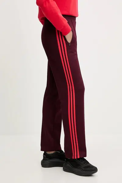 Tepláky adidas Originals GRFX Trackpants dámské, vínová barva, JW6058