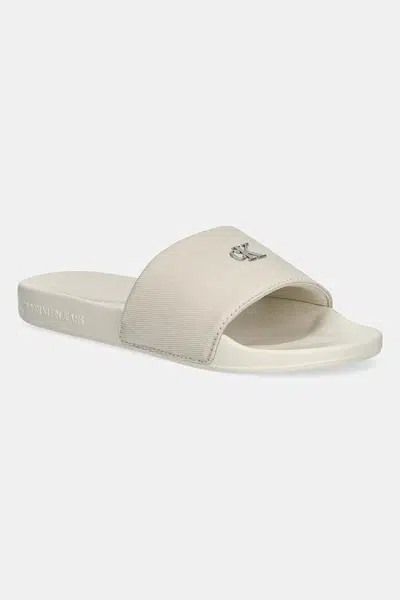 Pantofle Calvin Klein Jeans SLIDE MONOGRAM HARDWARE dámské, béžová barva, YW0YW01713