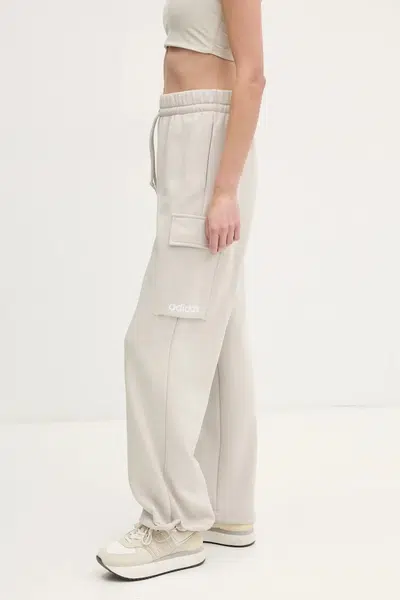 Tepláky adidas Essentials Linear béžová barva, hladké, JC5707