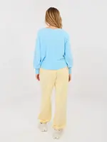 Svetložlté nohavice s kvetinovým detailom